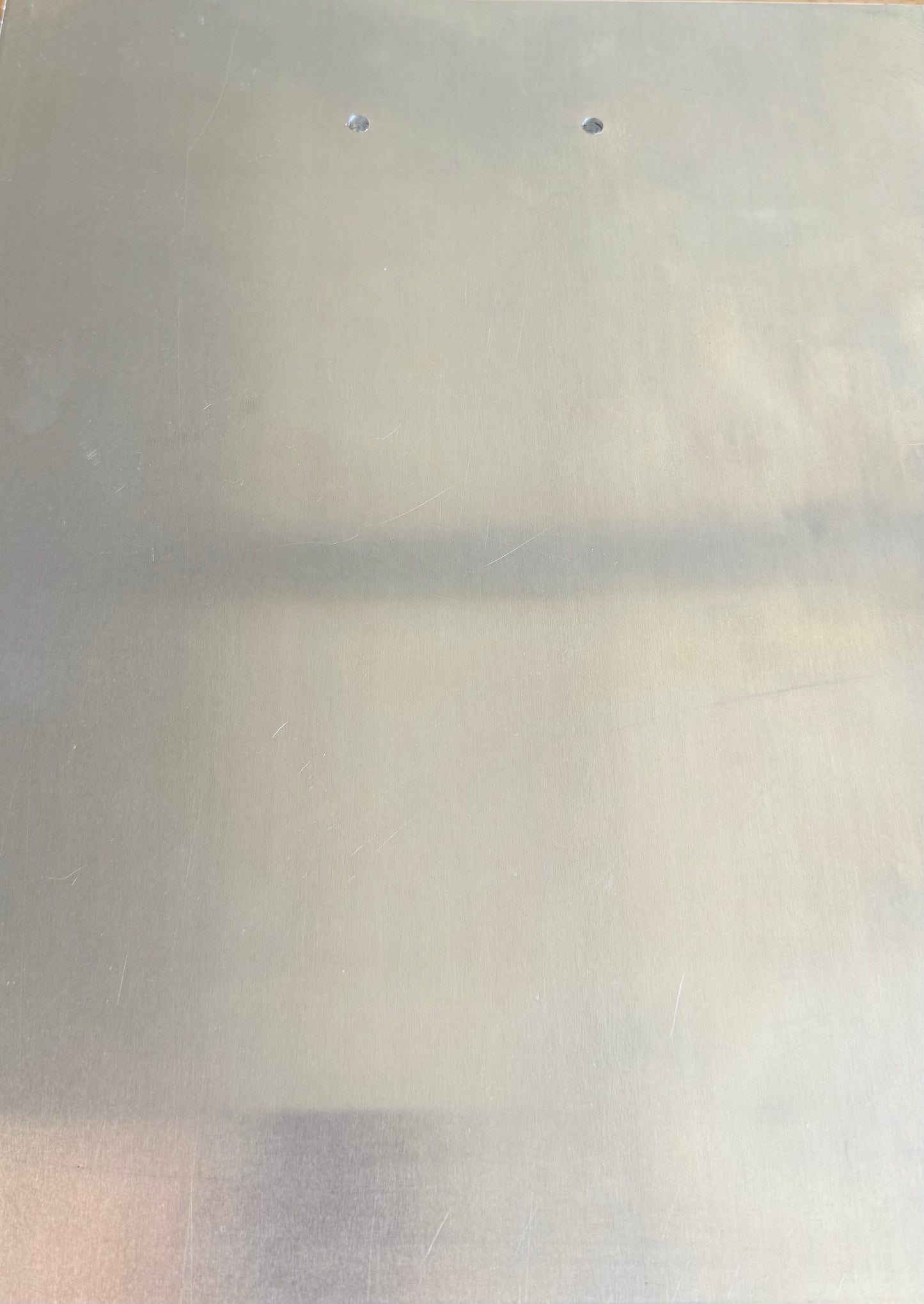 Aluminum back pad pre-drilled for manifold
